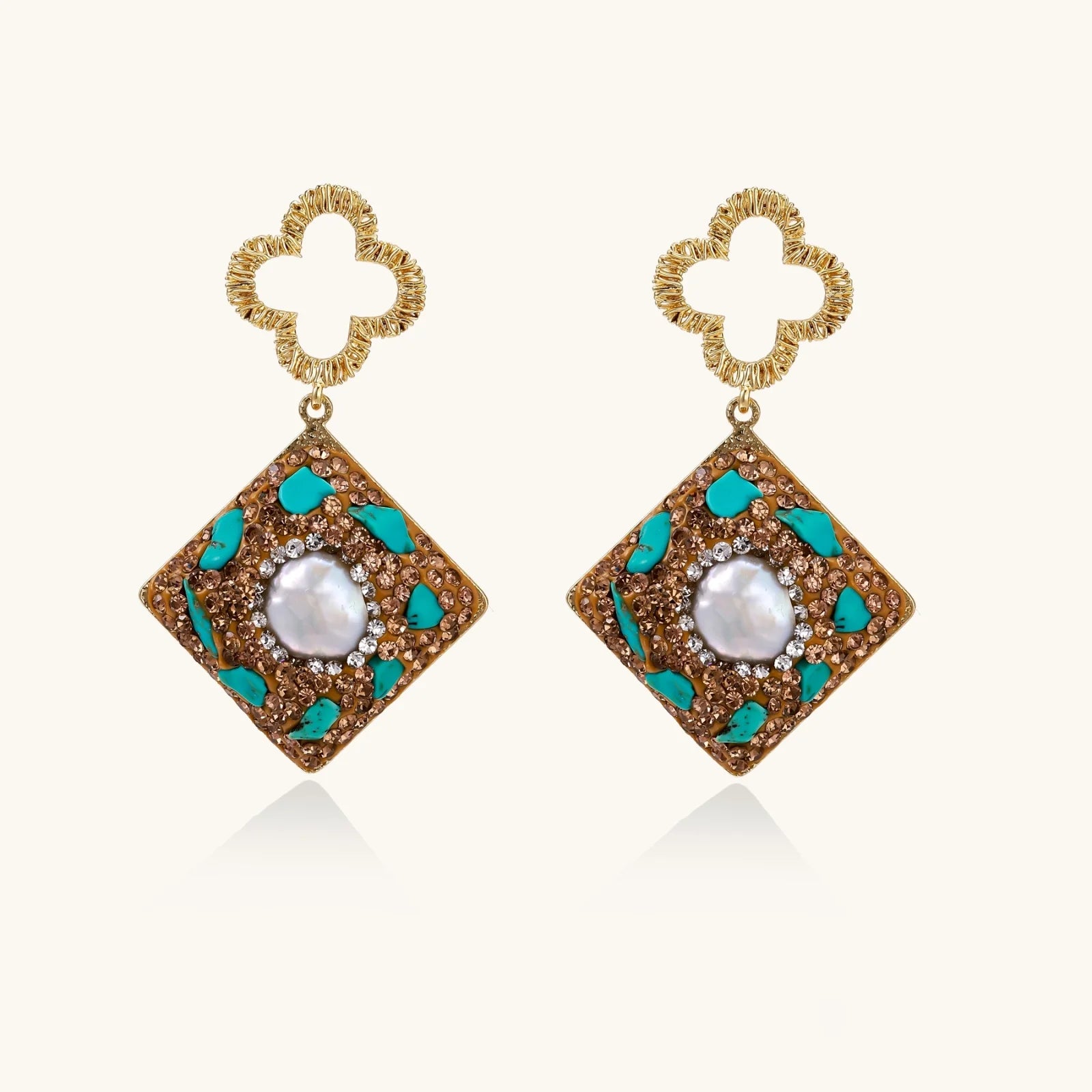Gold-plated drop earrings with quatrefoil studs, diamond-shaped pendants featuring baroque pearls, turquoise stones, and amber crystals