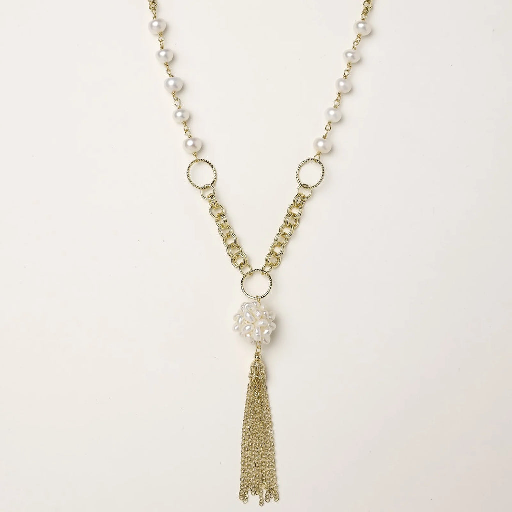 Long gold-plated necklace with freshwater pearls, chunky chain links, and flowing tassel pendant