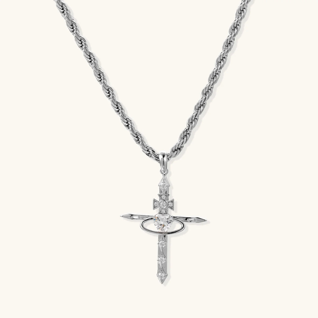 Silver-tone necklace with dimensional orb pendant, cross crown detail, and zirconia stones on twisted rope chain