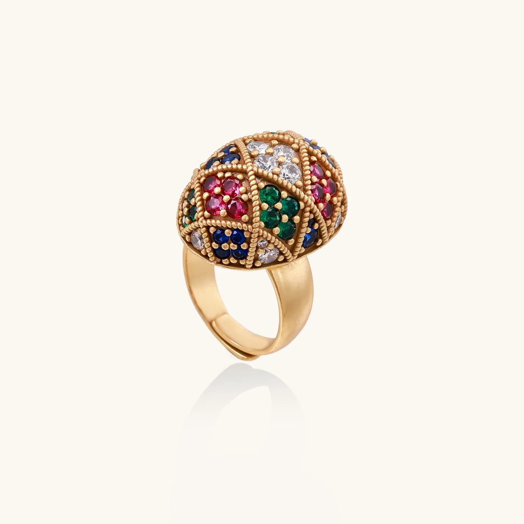 Oversized gold ring with geometric mosaic pattern featuring multicolor zirconia stones in ruby, emerald, sapphire, and clear tones.