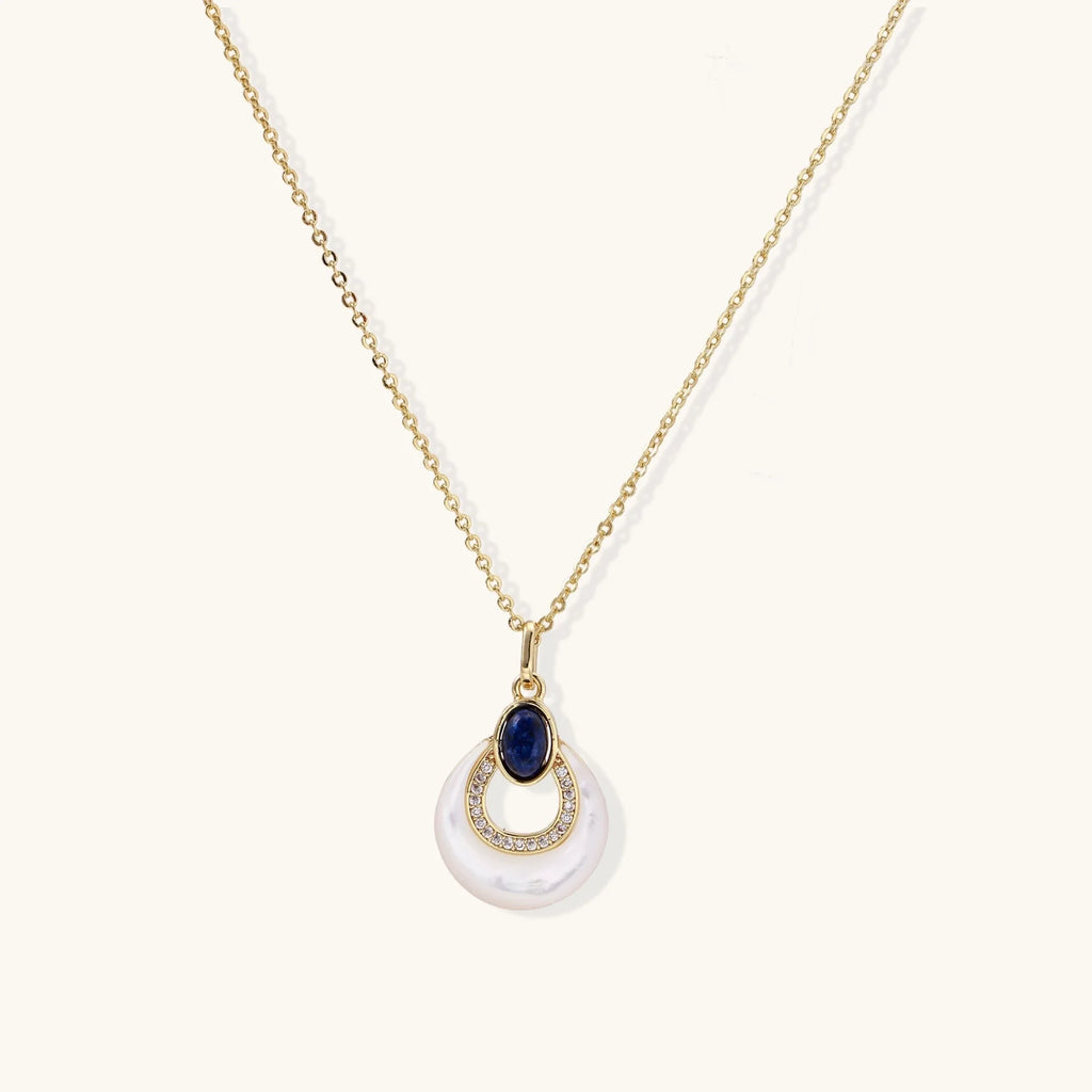 Gold necklace with navy lapis lazuli stone and iridescent mother-of-pearl teardrop pendant with crystal accents