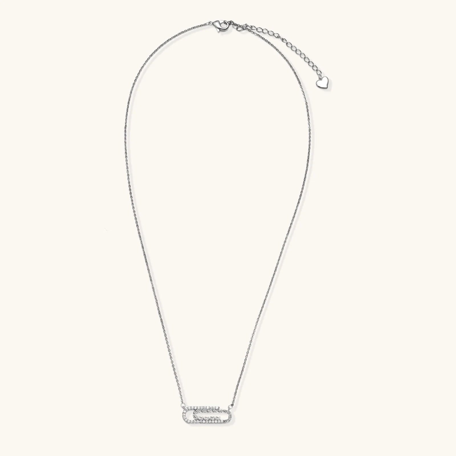 White gold plated necklace with dual-frame geometric pendant featuring crystal pavé border on pale background.