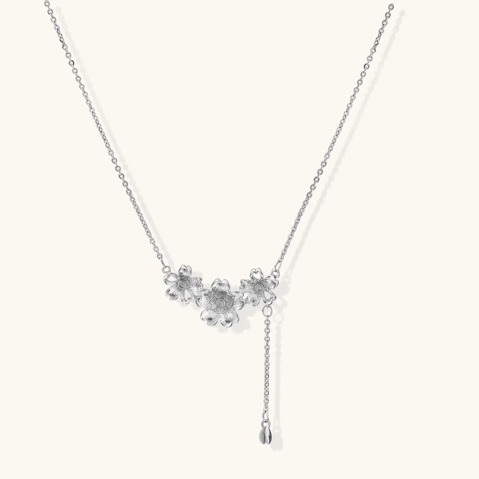 White gold plated Y-shaped necklace with three dimensional flower charms and adjustable drop pendant