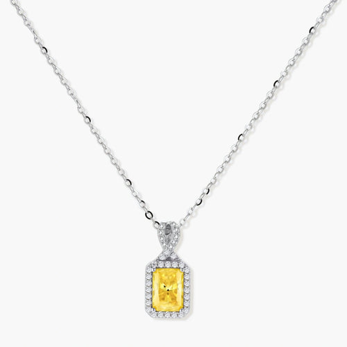 Rectangular yellow moissanite pendant in sterling silver halo setting on delicate chain against cream background.
