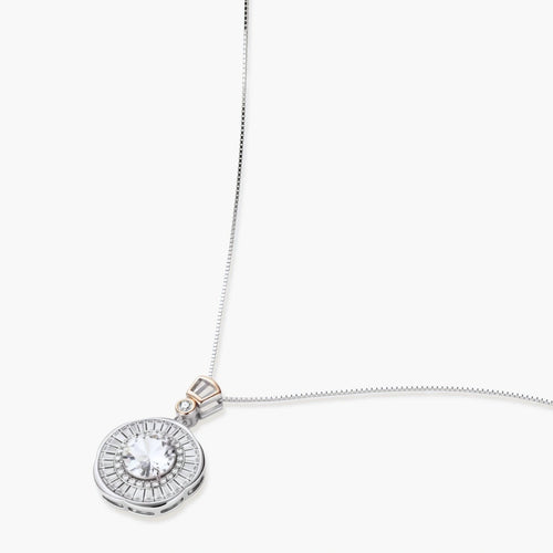 Sterling silver necklace with circular geometric pendant featuring central moissanite and radial baguette pattern.