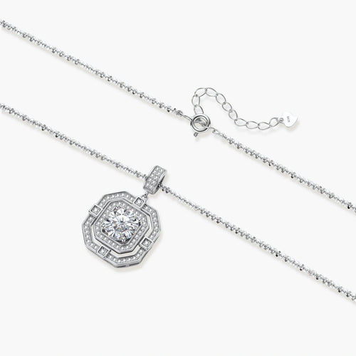 Sterling silver octagonal pendant necklace with brilliant moissanite center stone and halo setting on white background.
