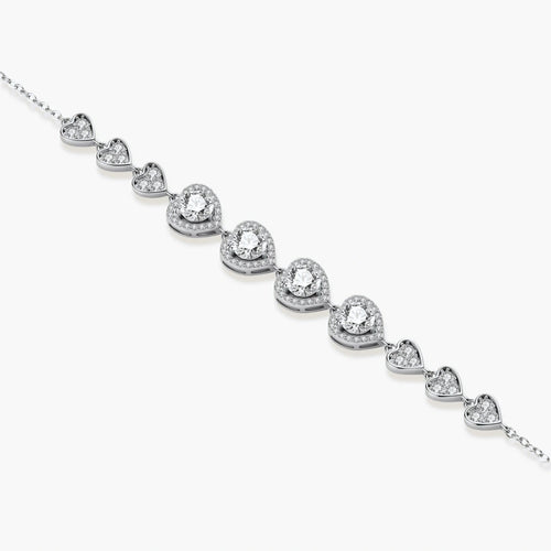 Sterling silver bracelet with graduated heart-shaped links and sparkling moissanite stones in VVS1 clarity on white background.