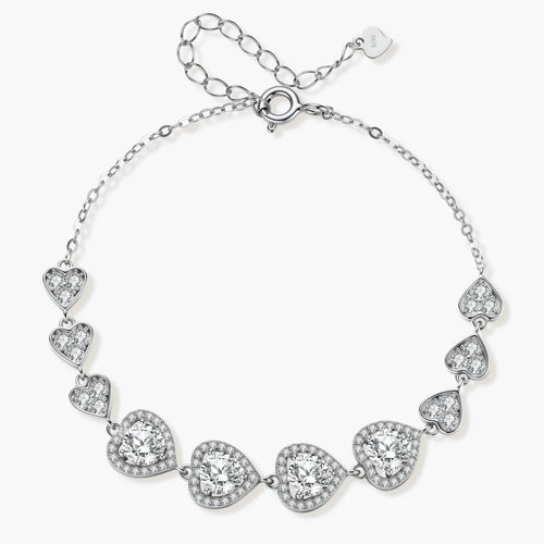 Sterling silver bracelet with graduated heart-shaped links and sparkling moissanite stones in VVS1 clarity on white background.