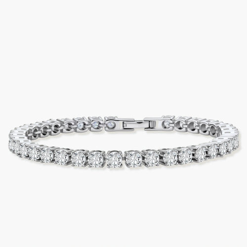 Sterling silver tennis bracelet with continuous row of brilliant moissanite stones and secure clasp closure on cream background.