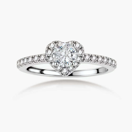 Heart-shaped halo ring with brilliant moissanite center stone surrounded by smaller crystals in sterling silver setting