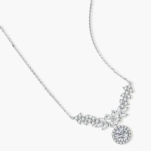 Elegant sterling silver necklace featuring intricate wing-like design with brilliant moissanite stones on neutral background.