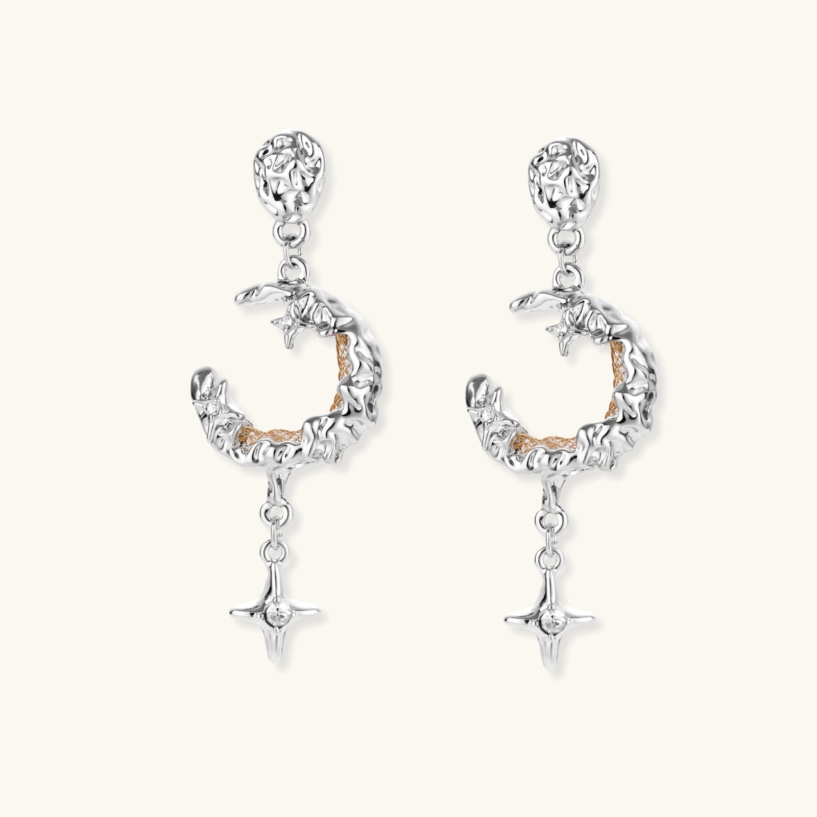 Detailed eco-brass dangle earrings featuring crescent moons with gold rope details and dangling star charms on white background.