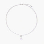 Dainty necklace with lavender crystal beads, freshwater pearls, geometric pendant, and large pearl drop on white background.