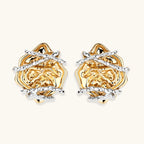 Sculptural rose-shaped stud earrings in gold with silver wire details and S925 posts on cream background.