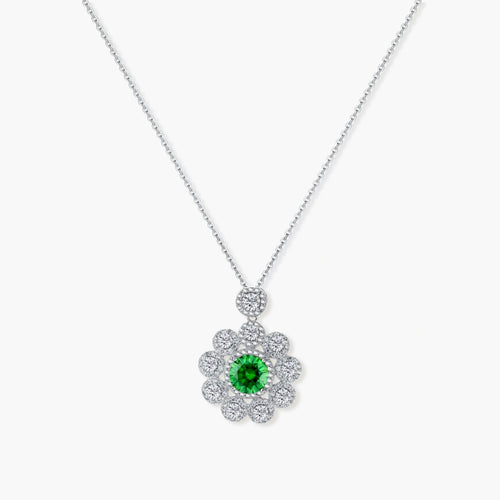 Delicate sterling silver necklace with flower-shaped pendant featuring bright green center moissanite and clear accent stones