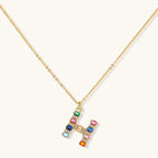 Gold-plated letter H jewelry set with multicolor zirconia stones in emerald cuts, showing necklace pendant and matching earrings