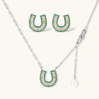 Geometric horseshoe-shaped jewelry set with radiating white zirconia center and jade-green border stones on white background.